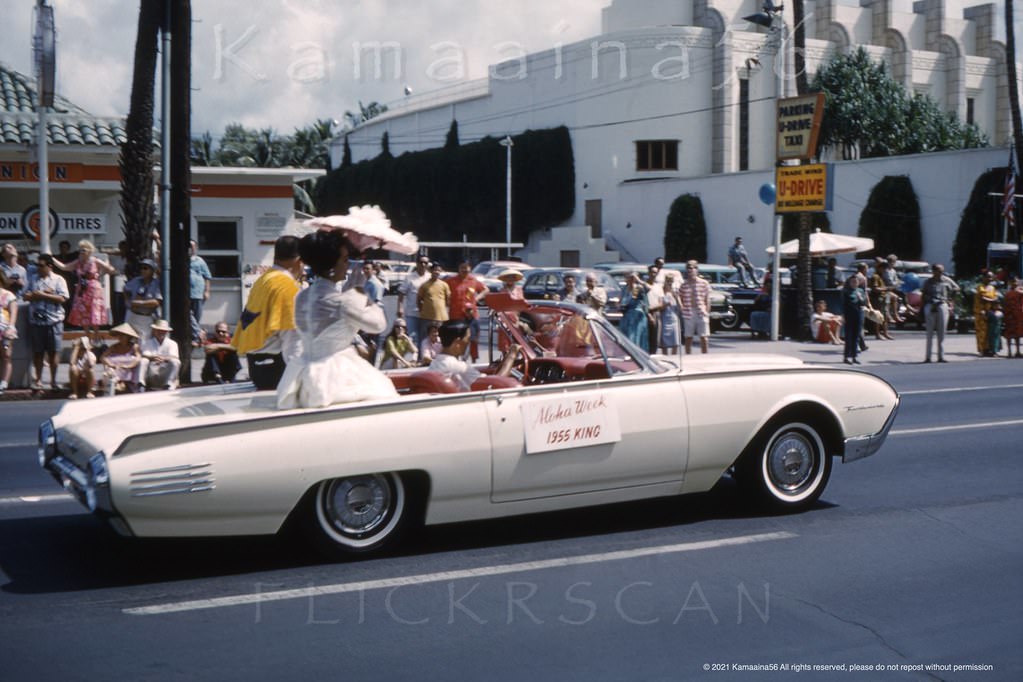 #70 Aloha Week parade on Kalakaua Avenue just east of Seaside Avenue with a couple of old Waikiki buildings still standing in the background, 1961