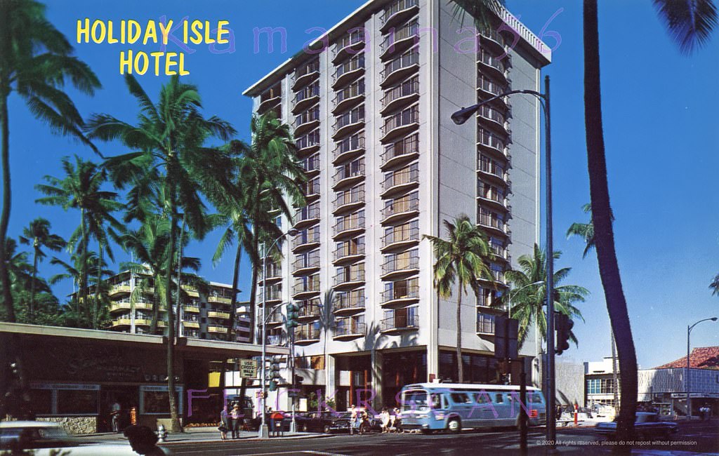 #111 Street level view of the 14 floor Holiday Isle Hotel on the makai side of Kalakaua Avenue at Lewers Street, 1960