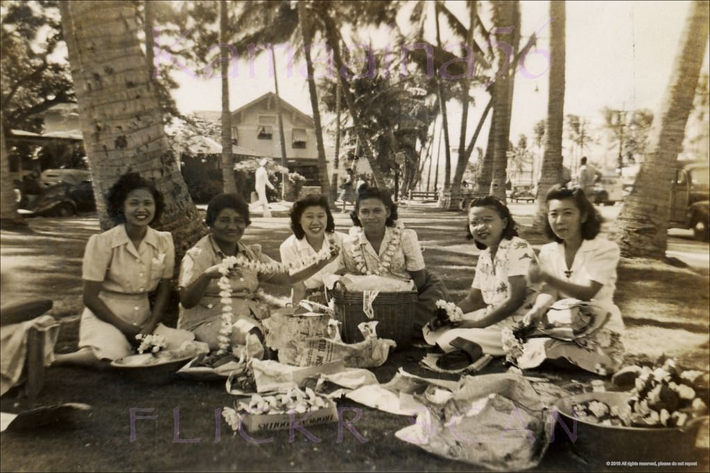 #41 Lei stringers at the park on the makai side of Kalakaua Avenue at Beachwalk, 1940s