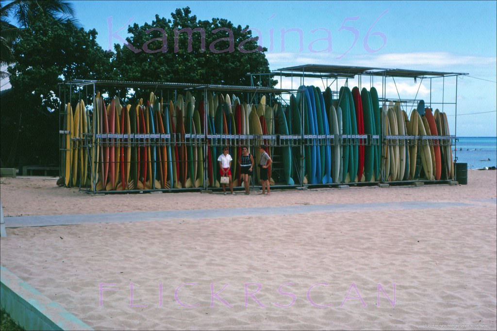 #175 Rental surfboard racks at the Waikiki Beach Center seen from Kalakaua Avenue, 1963