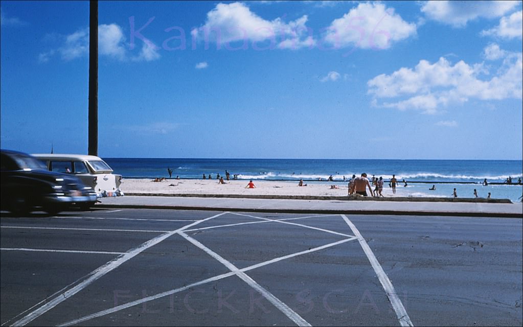 #179 Mid-afternoon sun at the Kuhio Breakwater viewed from the Kealohilani and Kalakaua intersection in Waikiki, 1960
