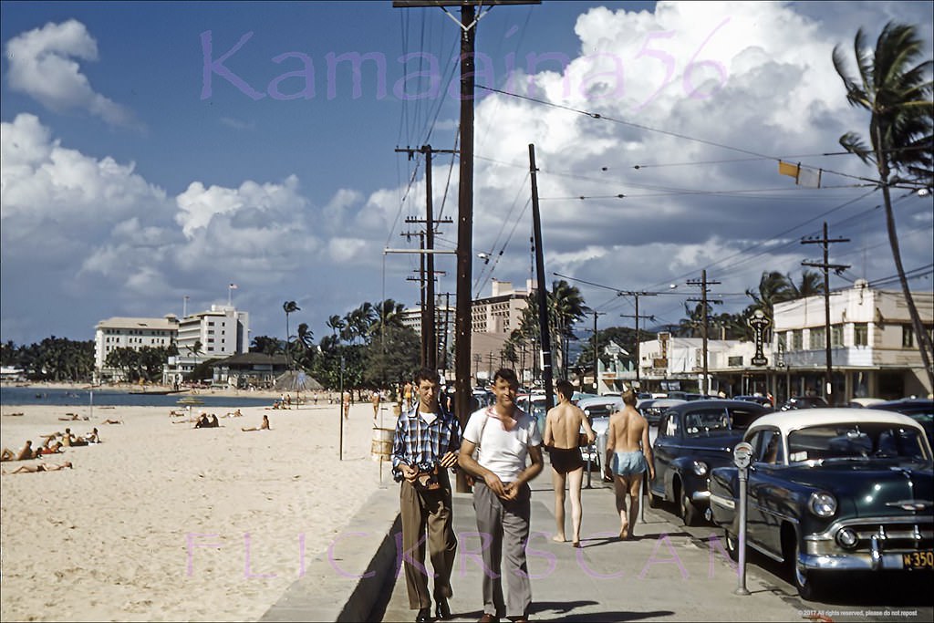 #233 Street level snap of Waikiki’s Kalakaua Avenue looking west back when there was still two-way traffic and on-street metered parking, 1956