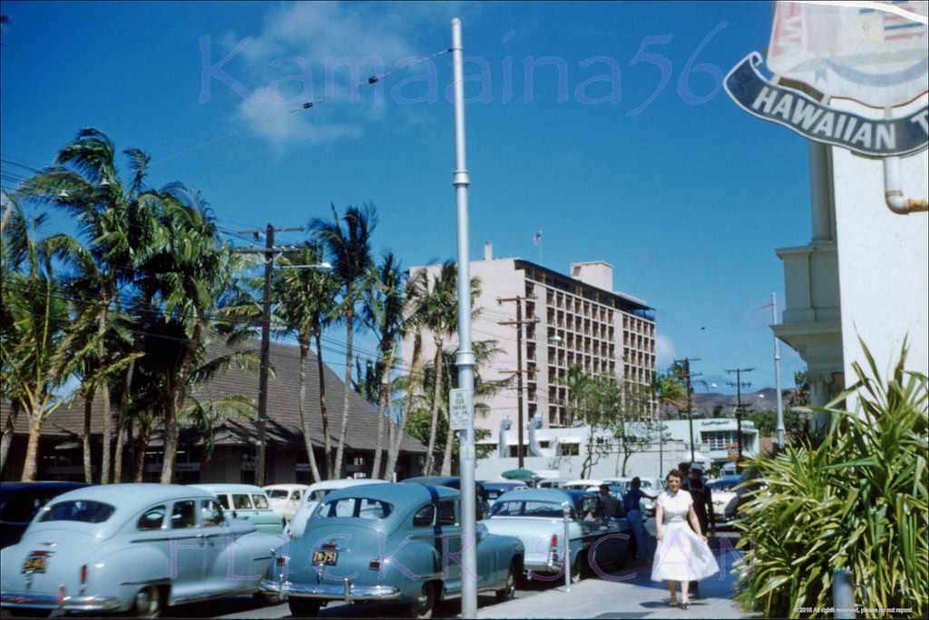 #34 Street scene looking east along Kalakaua Avenue from the driveway at the Outrigger Canoe club next to the Moana Hotel, 1955