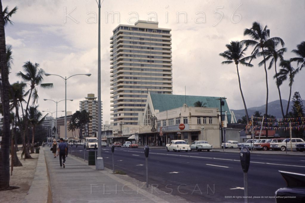 #145 Kind of a grim view of the Diamond Head (east) end of Waikiki’s Kalakaua Avenue looking Ewa (west) from between Paoakalani and Kapahulu Avenues, 1964