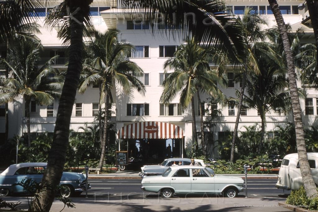 #20 The porte-cochere entrance to the stately Moana Hotel seen from across Kalakaua Avenue, 1962