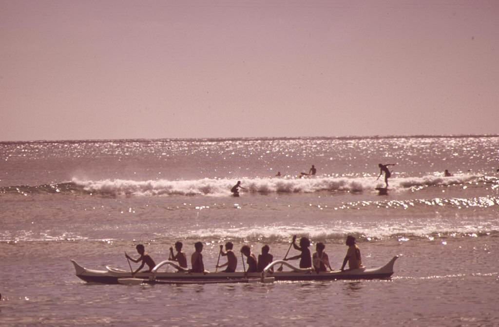 #28 Outrigger canoes and surfers at Waikiki Beach, Honolulu, 1973