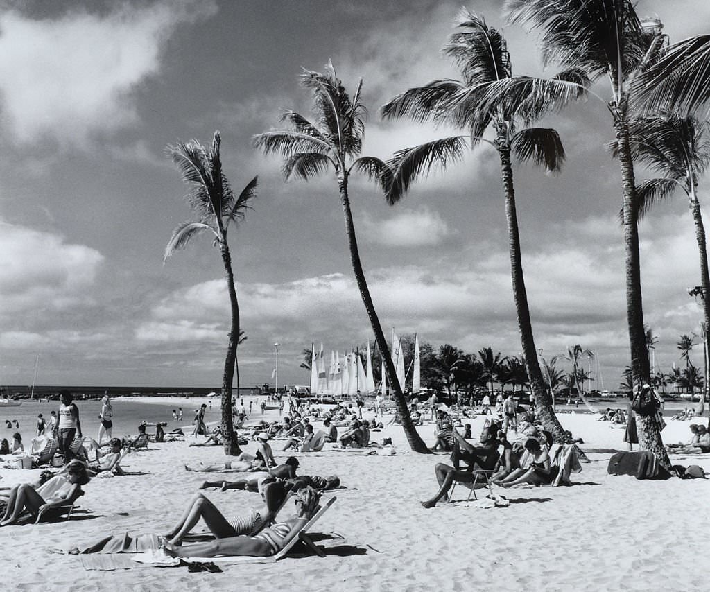 #37 A packed beach with people sunbathing and enjoying the sea, 1970