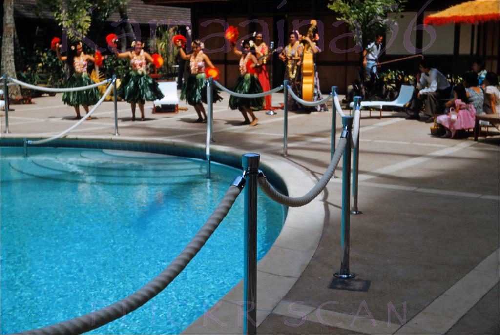 #48 Hula dancers with uli-uli at the Princess Kaiulani Hotel pool court, 1955