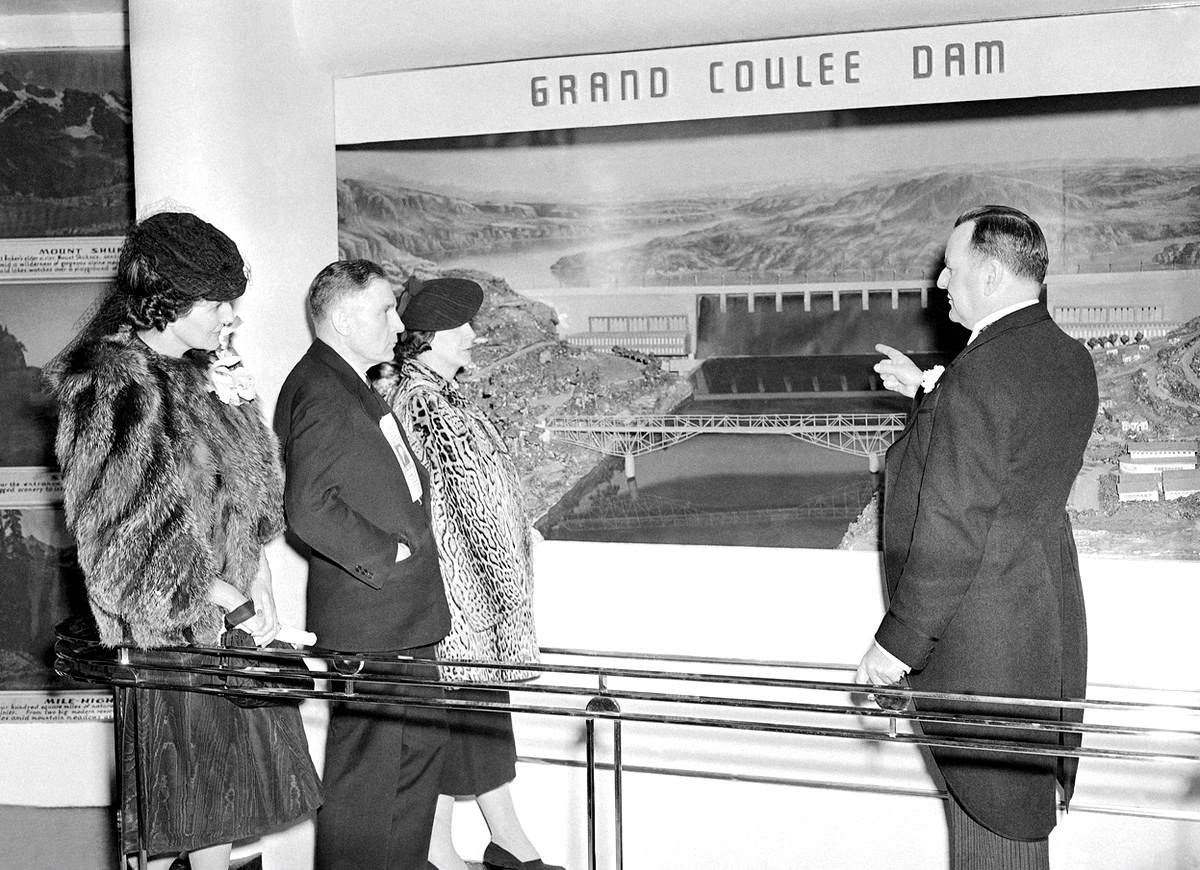 #16 Prominent representatives of the state of Washington look at a diorama of Grand Coulee dam, part of their state’s exhibit at the New York World’s Fair on May 1, 1939,