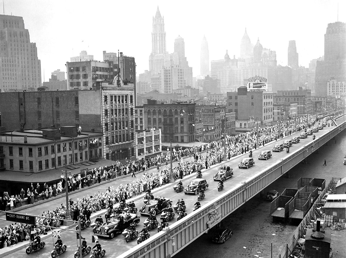 #3 With New York City as a backdrop, King George VI and Queen Elizabeth (first car) proceed up the Westside highway along the Hudson en route to the New York World’s Fair.
