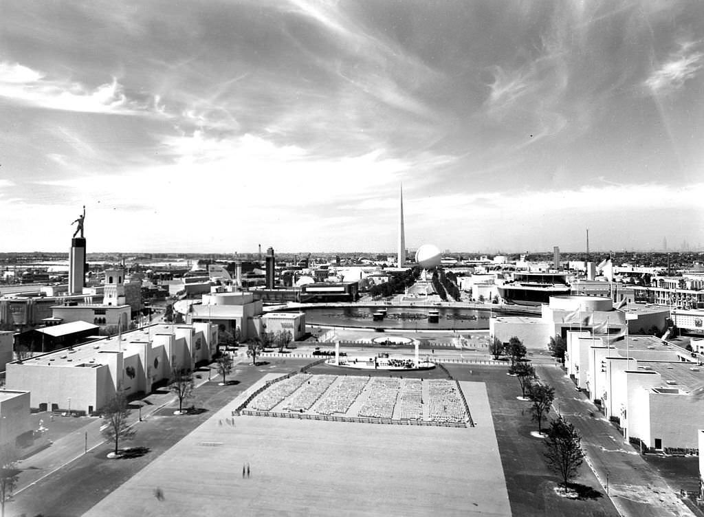 #90 Overall view of the fairgrounds at the New York World’s Fair of 1939, New York. The USSR building’s statue of a worker is visible on the left, and the Trylon and Perisphere are visible in the center background.