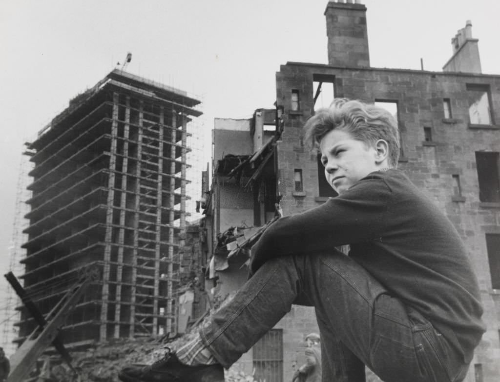 #97 Eleven years old Gorbals boy Willie Thomason still comes back to his old territory among the old tenements and watches the progress being made by workmen.