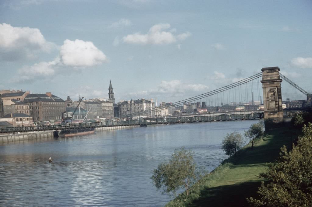 #84 View from the south bank Laurieston and Gorbals area of the South Portland Street Suspension Bridge spanning the River Clyde in Glasgow, 1965.
