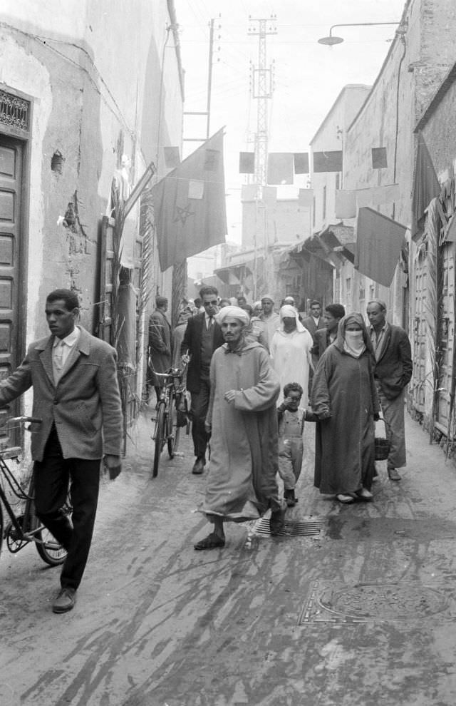 #8 People walking through narrow street in souk, 1960s