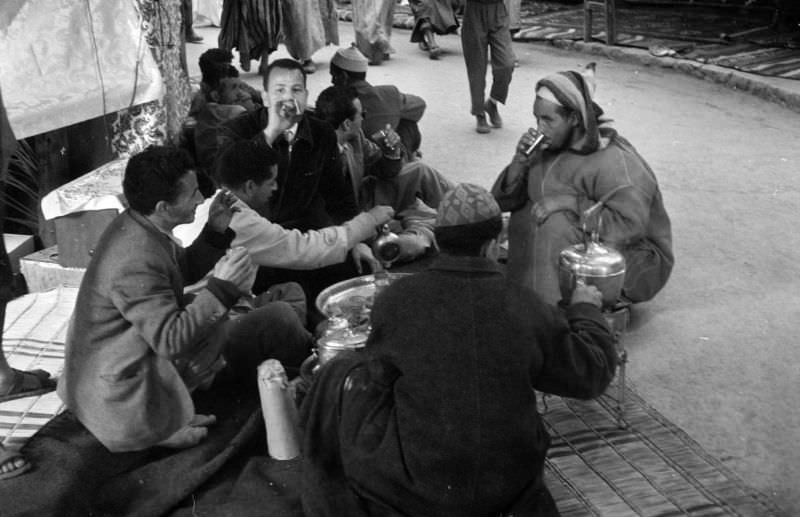 #86 Seated men drinking tea at souk in Marrakech, 1960s