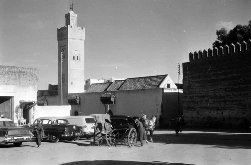 #89 Horse-drawn carriage parked next to automobiles in Fez, 1960s