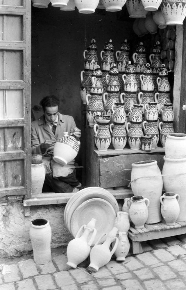 #90 Man finger-painting vases in Rabat pottery shop, 1960s