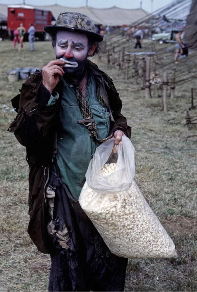 #7 Emmett Kelly, one of the very best of all clowns with a large popcorn bag.