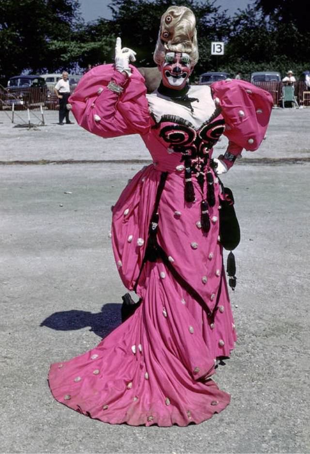 #6 Ernie Burch, a clown in a long red dress.
