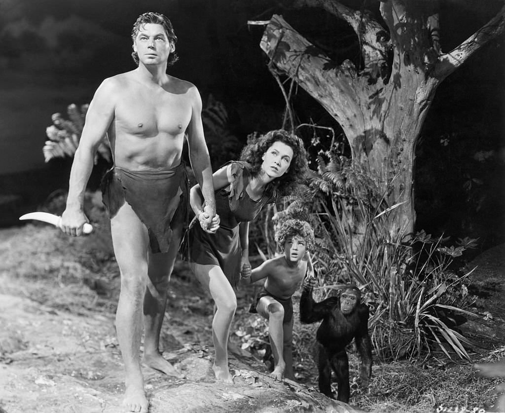 #30 Johnny Weissmuller adn Maureen O’Sullivan, and kid (Johnny Sheffield), with chimp.