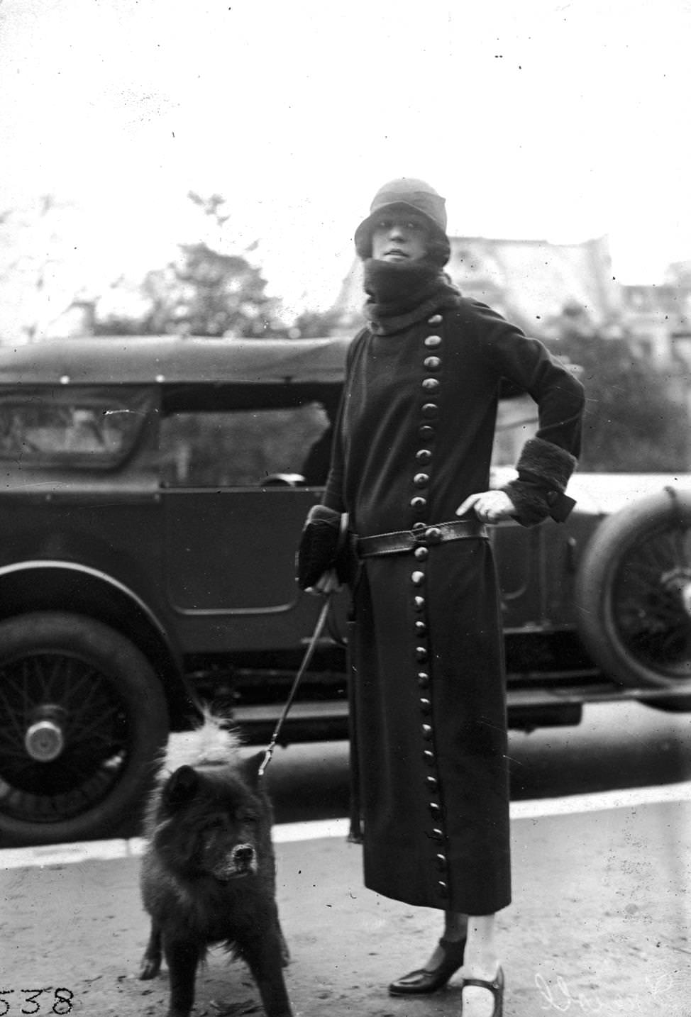 #136 A Drecoll winter coat worn with a belt and with large buttons fastened from the neck to the hemline, 1920s