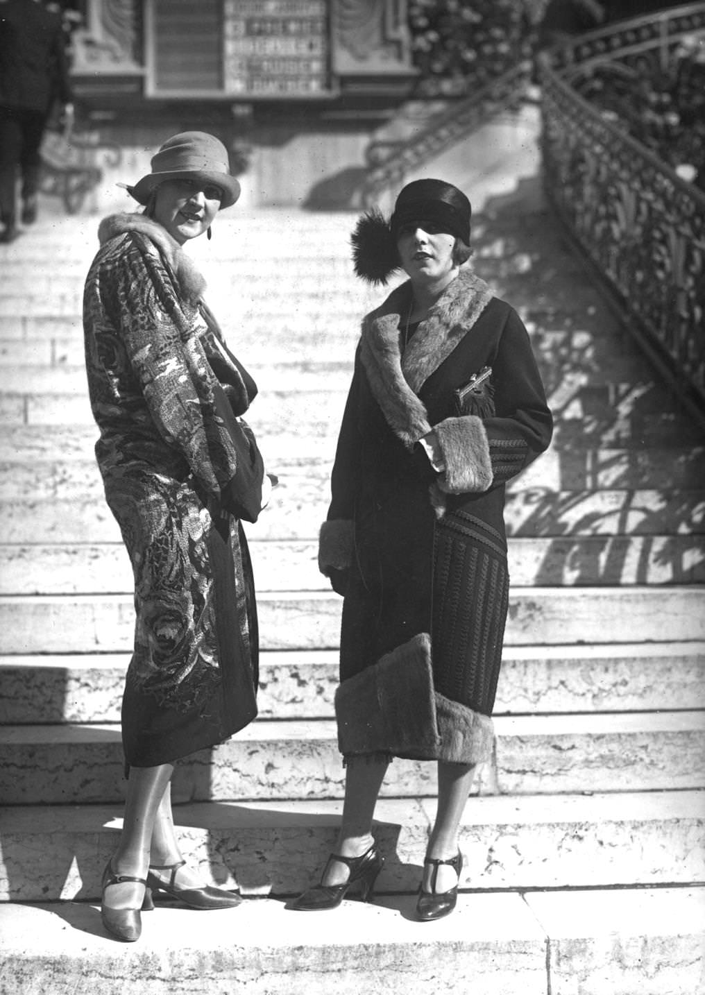 #142 A model wearing a printed silk coat, with a model wearing a fur-lined coat and decorative hat, 1924