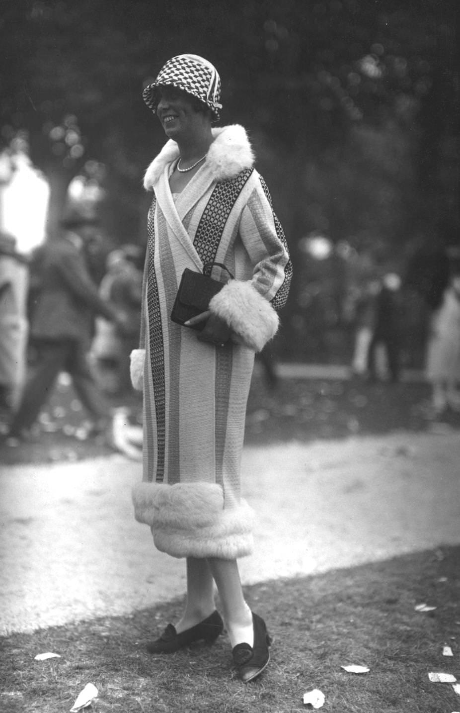 #160 A stripy wraparound coat with fur trim, straight from the fashionable town of Deauville in northern France, 1925