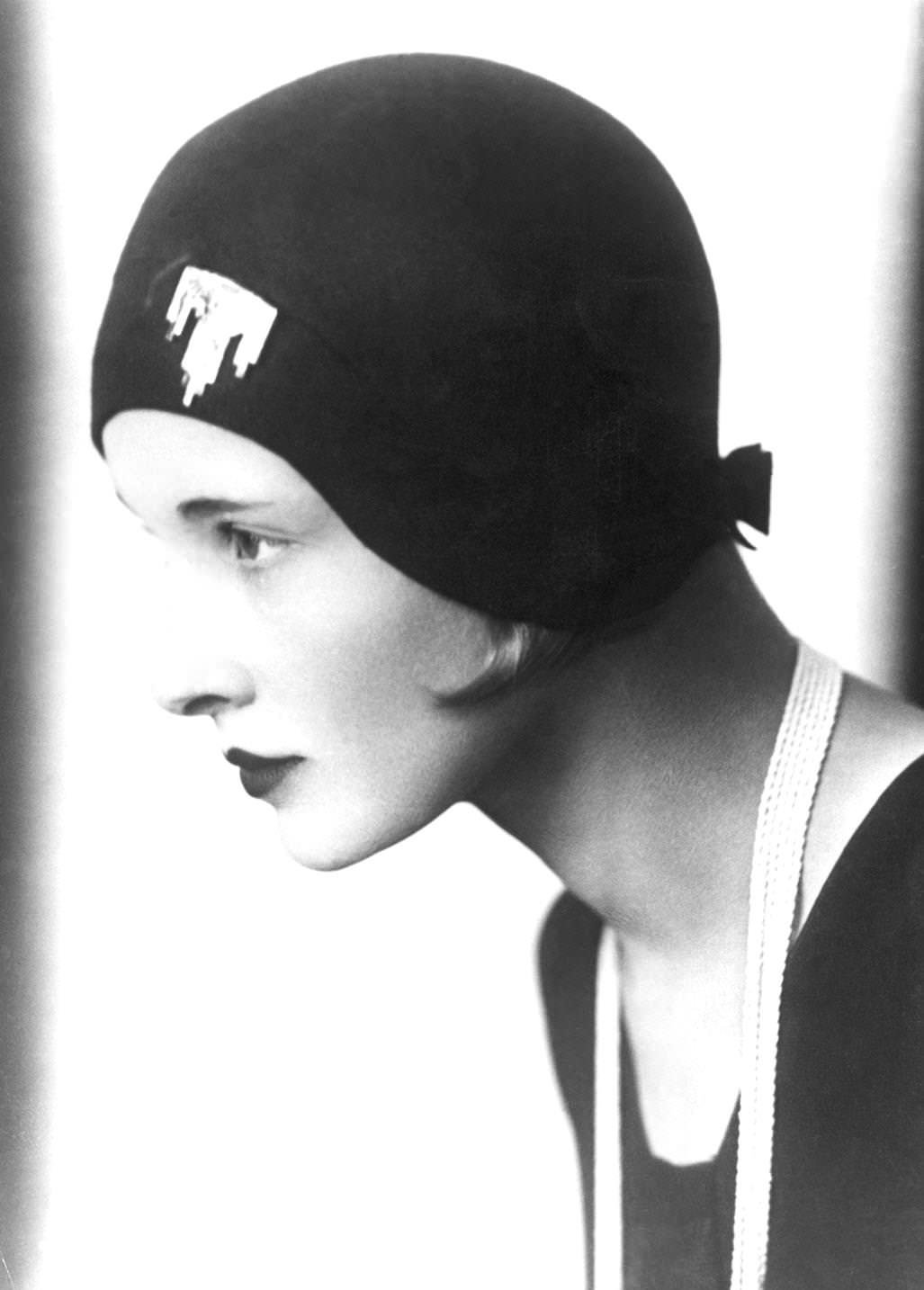 #2 A woman modeling a hat fitted with a brooch on the front and a bow on the nape of the neck, 1925