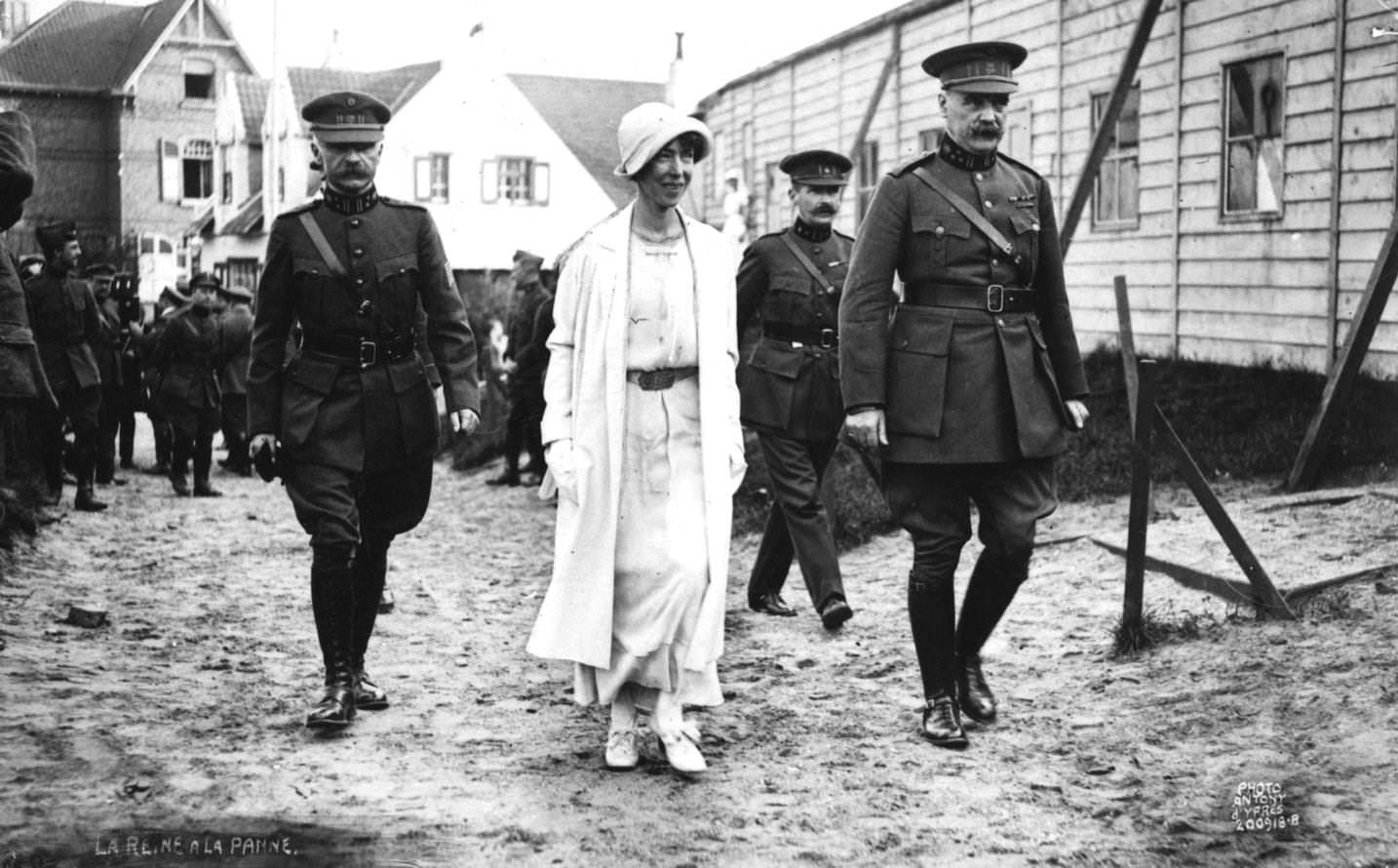 #35 Elizabeth, Queen of the Belgians (1876 – 1965) in cloche hat, wife of King Albert, accompanied by soldiers, 1920