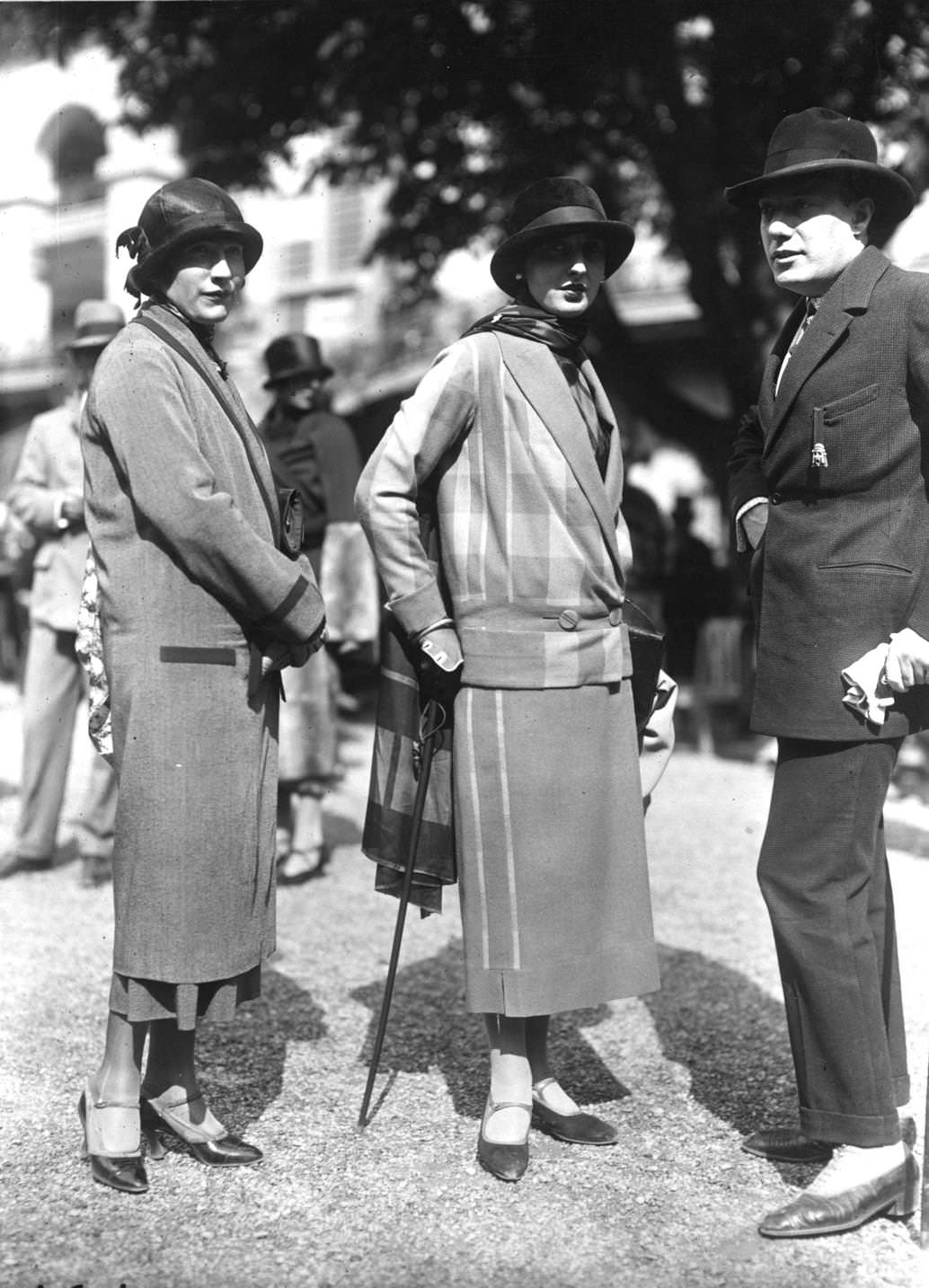 #44 A seven-eights straight coat with a small brimmed cloche hat and a suit with waist length v-necked jacket and long scarf, 1924