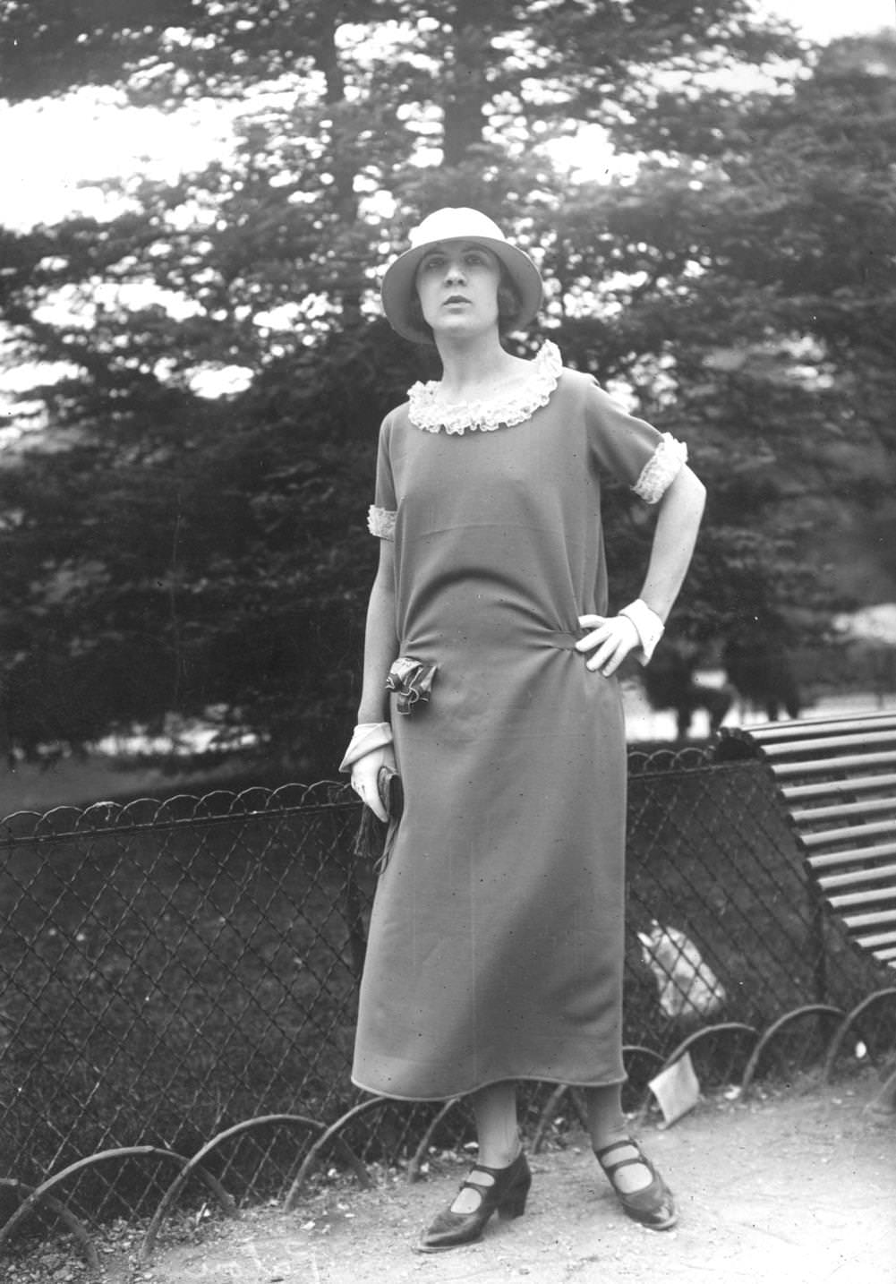 #76 A model wearing a dress with a lace lined collar and cuffs and a pair of ornametal gloves, 1923
