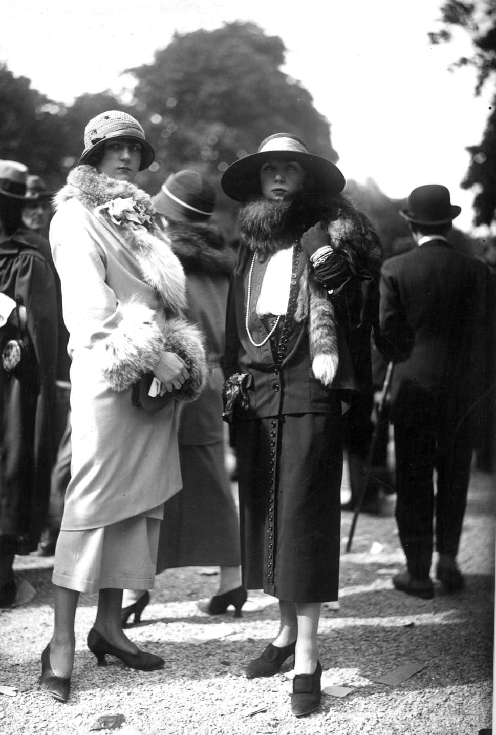 #82 Dress and fur trimmed coat worn with a cloche hat and plain court shoes and a suit with front fasteninghigh waisted skirt, worn with a fox fur, a large-brimmed hat, 1923