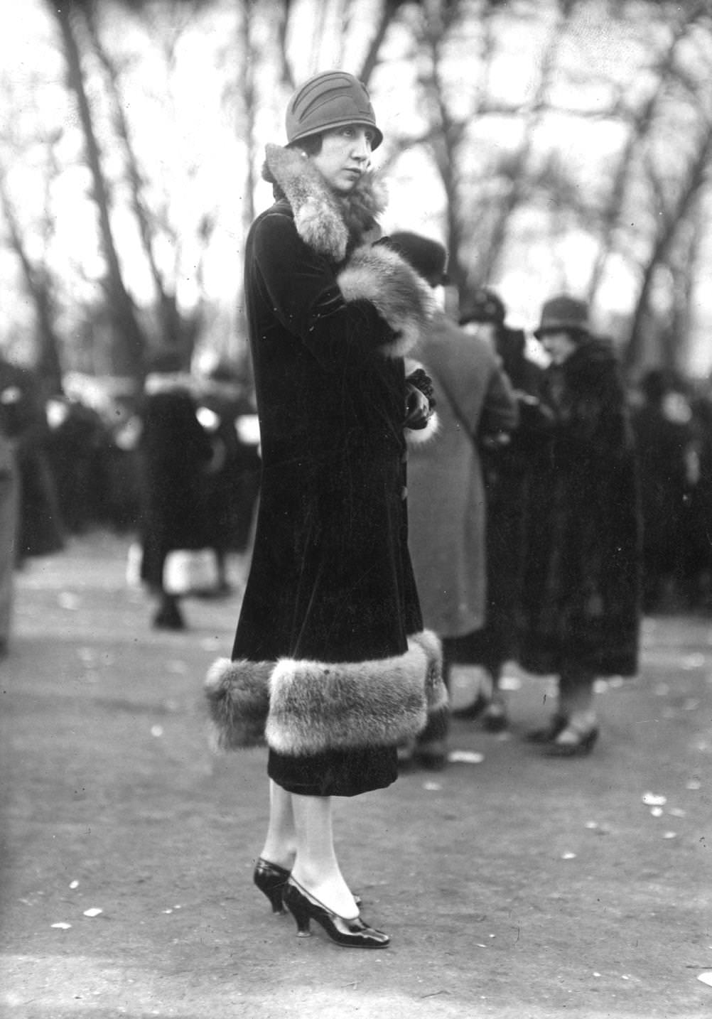 #88 Velvet coat with fur trim around the cuffs, collar and hemline, and a felt cloche hat, illustrating the latest Parisian fashion, 1925