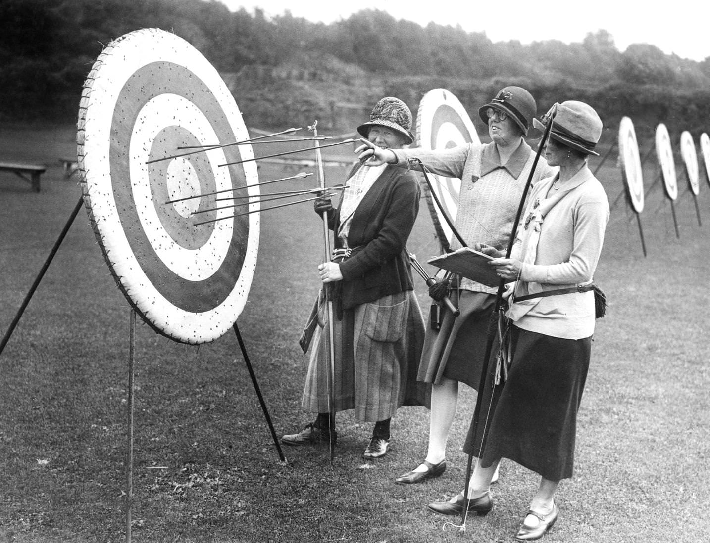 #94 Female competitors checking their scores as they stand before a target during the Southern Counties Archery meeting, held at the Nevill Cricket Ground in Royal Tunbridge Wells, Kent, England, 1925