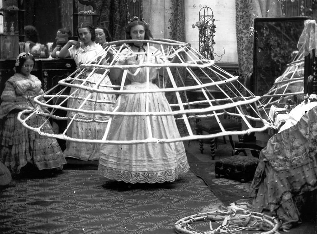#18 The scene from a ladies dressing room, preparing for the crinoline, 1860