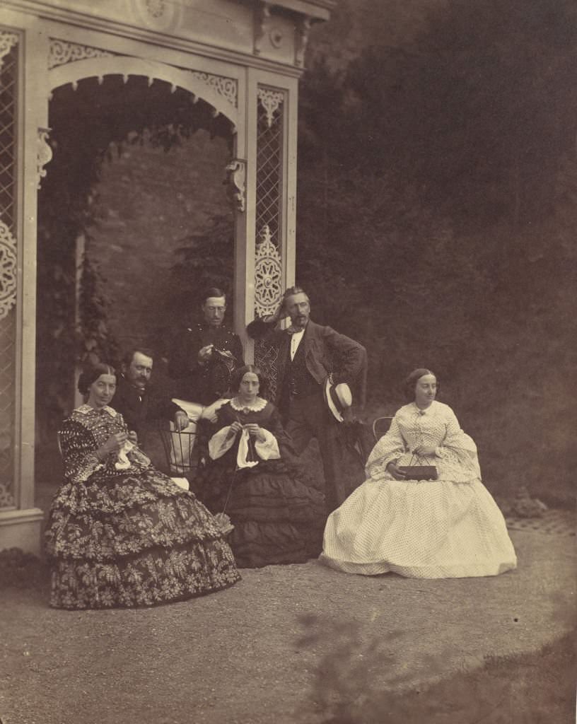 #33 Three Women in crinolines and men in a Garden, 1850