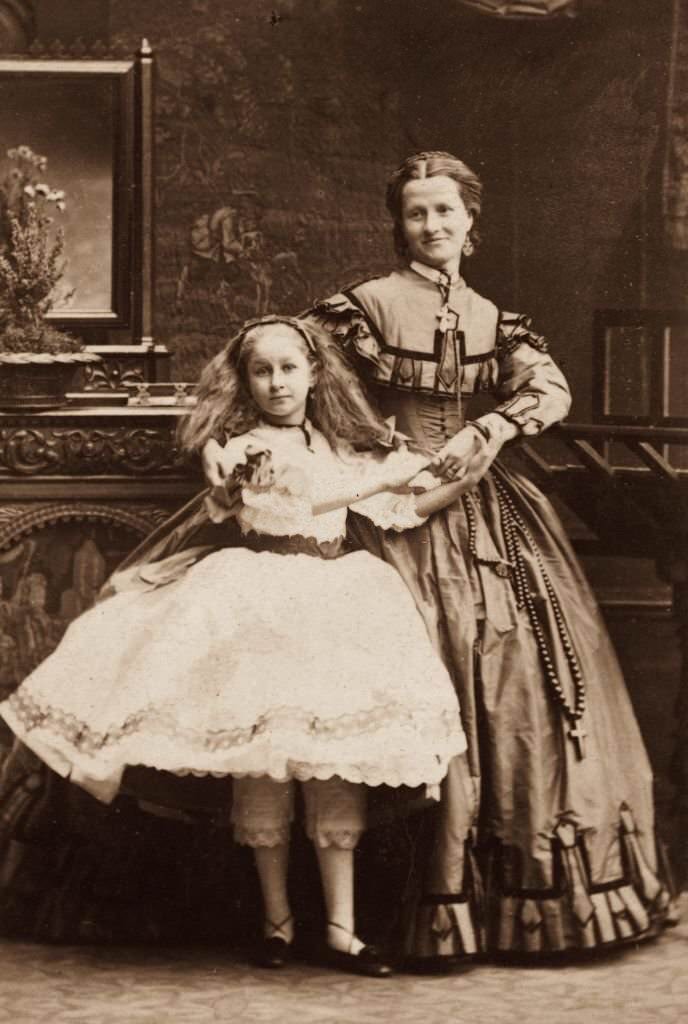 #51 A young girl and an older woman in Victorian knickerbockers and full skirts, 1860