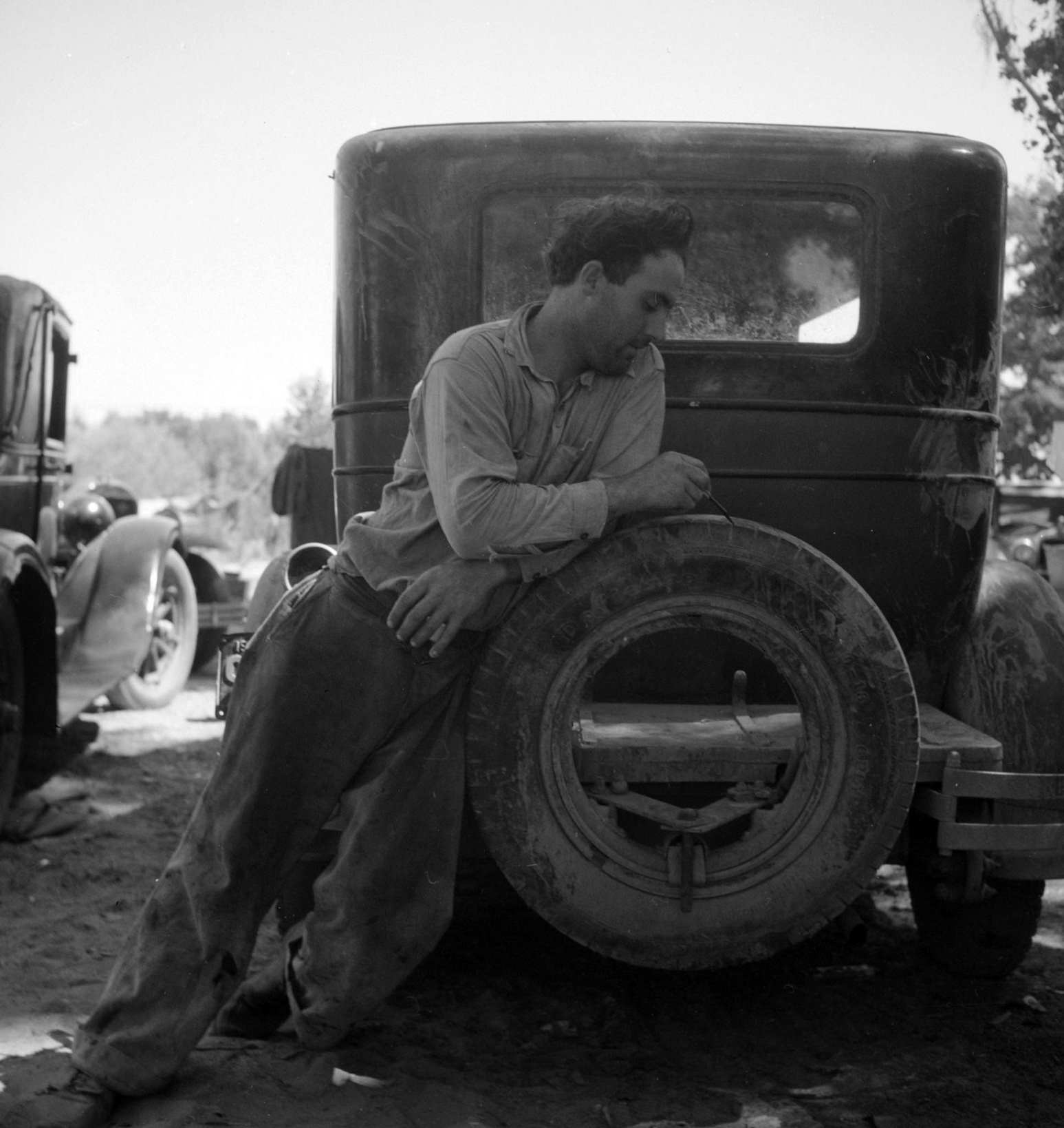 #33 Migrant agricultural worker in Marysville migrant camp (trying to figure out his year’s earnings). California, 1930s