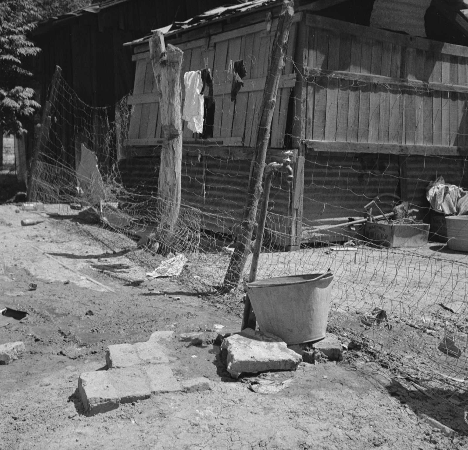 #65 Home of Mexican field worker showing water supply. Brawley, Imperial Valley, California, 1930s