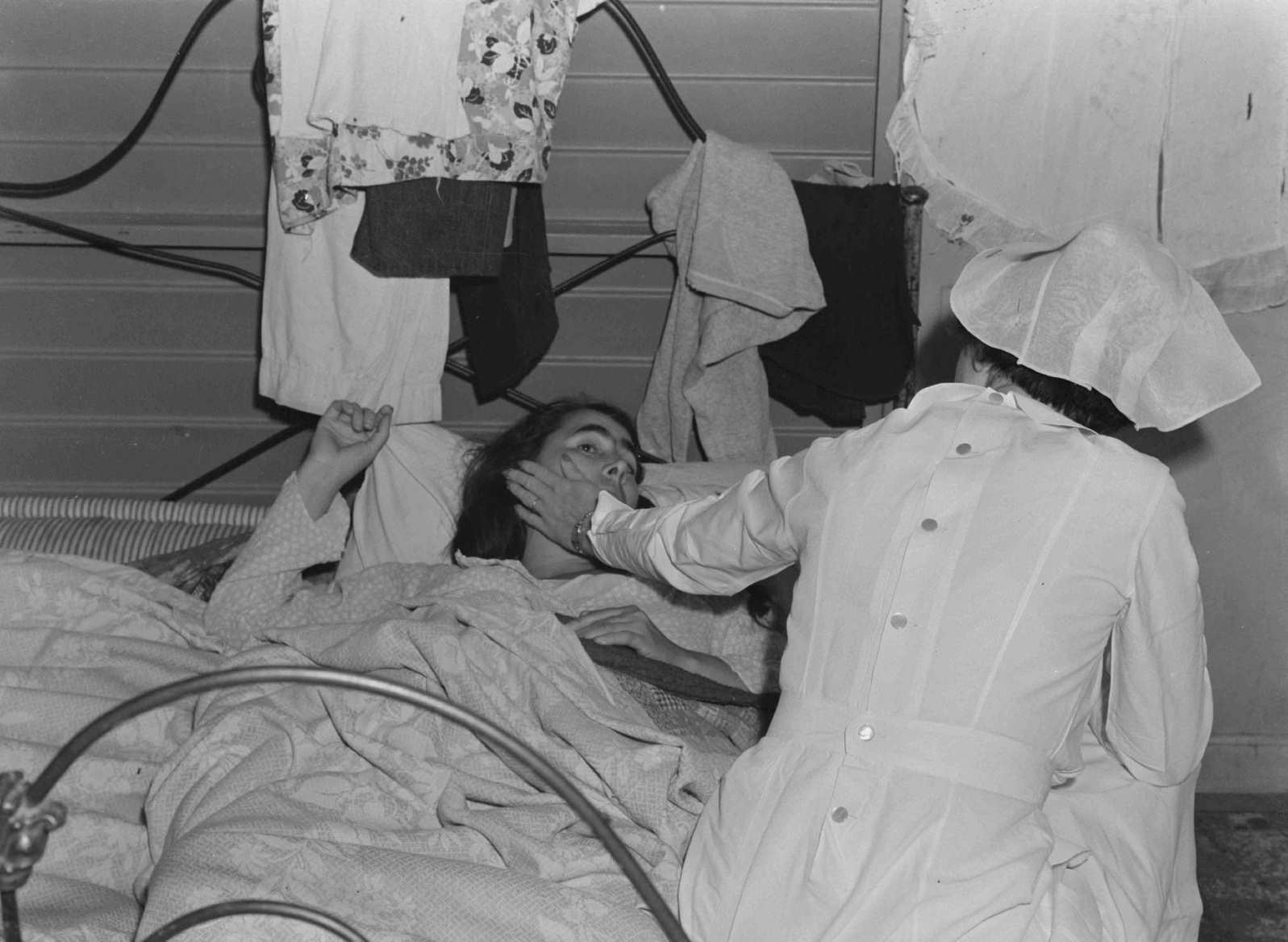 #84 Nurse with patient at a Farm Security Administration camp for migratory agricultural workers at Farmersville, 1938