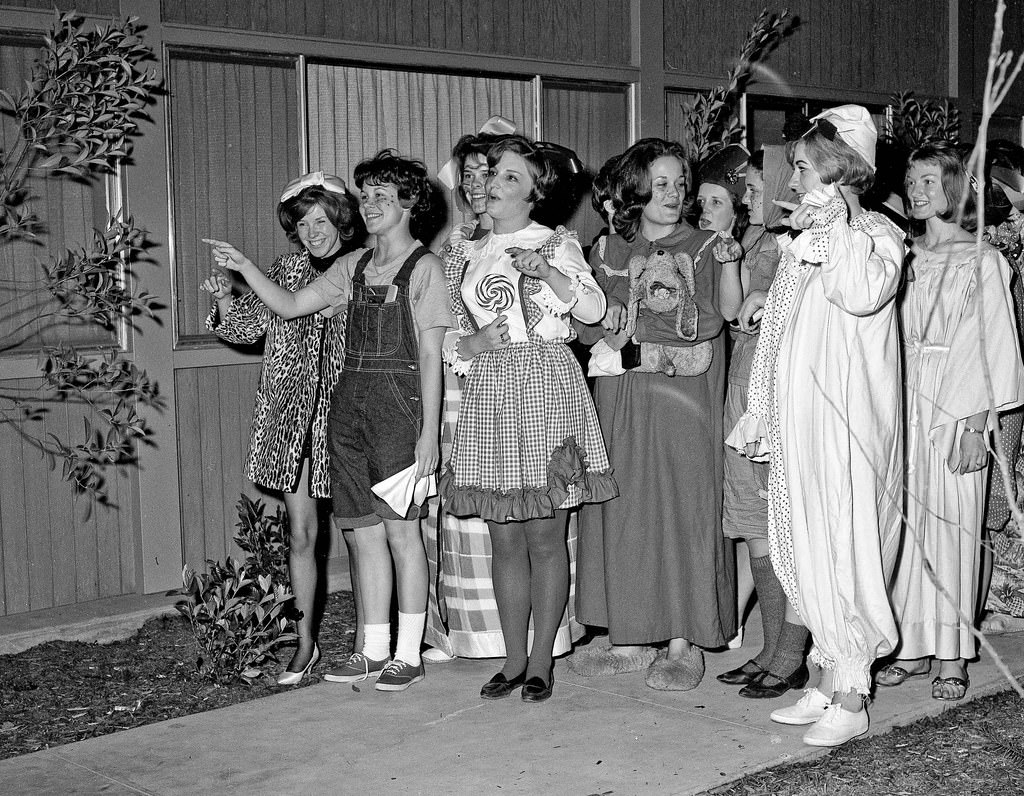#31 A bunch of co-eds having a costume party at a near-by women’s dorm, walked over to serenade at the neighboring men’s dorm, 1964