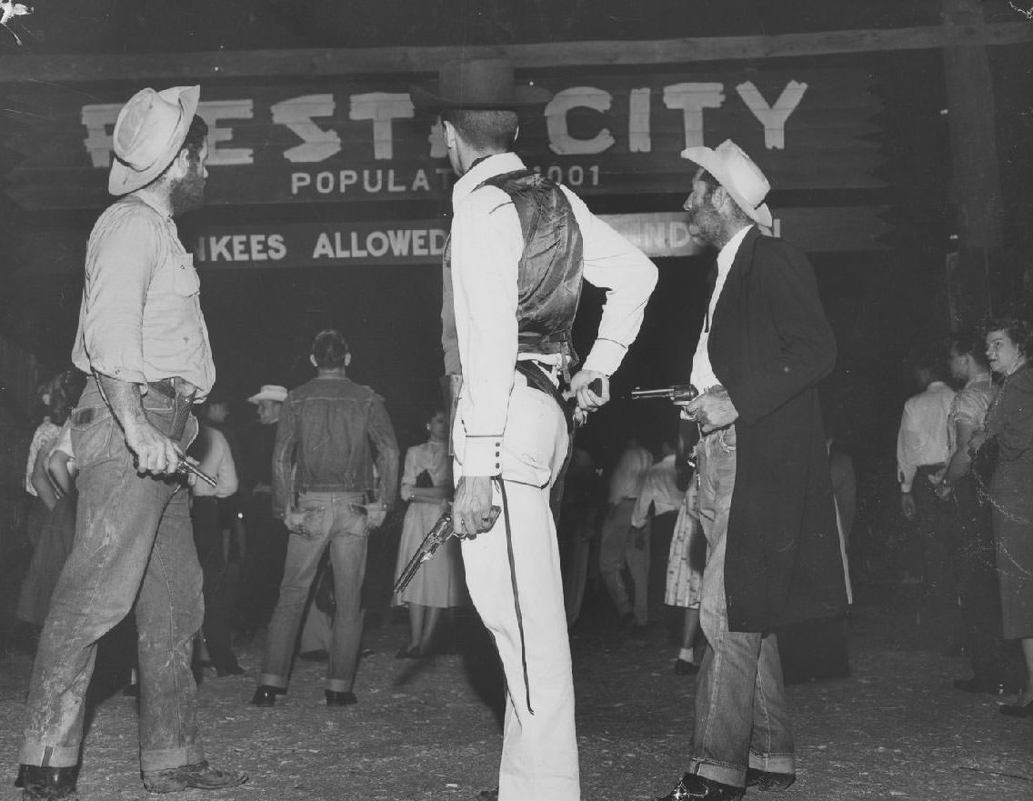 #9 Students dressed as outlaws near the Fiesta City gate, 1950s