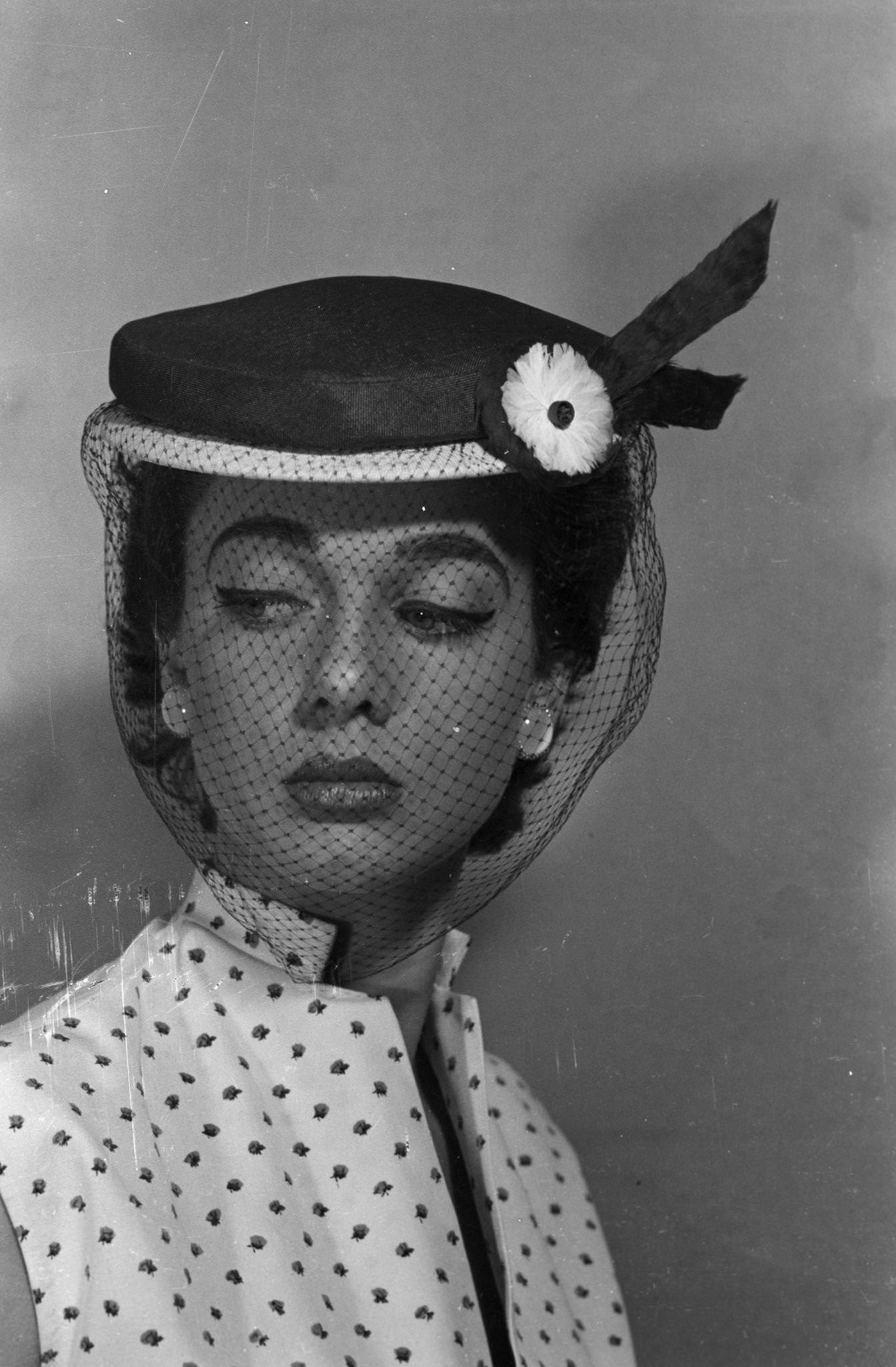 #113 Model presenting hats of spring by Jacques Fath, 1953