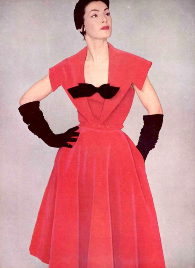 #11 Lucky in pink geranium velvet cocktail dress adorned with black ribbon bow, by Jacques Fath, 1951