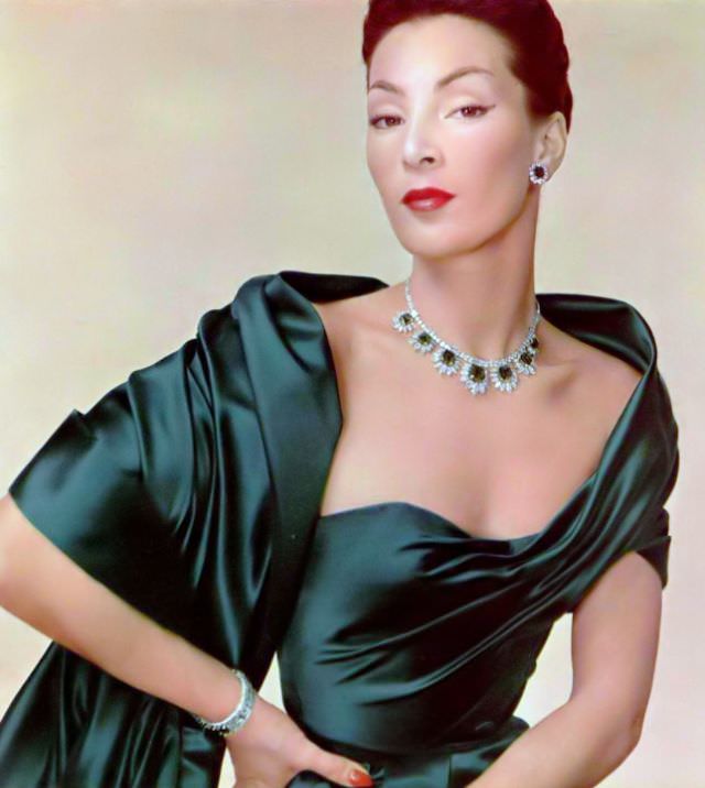 #12 Lucky is wearing emerald green satin evening gown by Jacques Fath to compliment magnificent emerald and diamond parure by Cartier, 1951