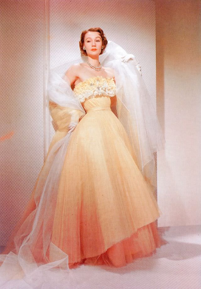 #13 Sophie Malgat in Fath’s dégrade orange pleated tulle evening gown with floral bodice called “Sunbeam”, April 1951