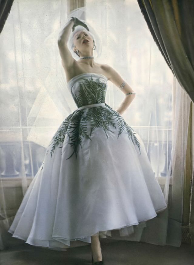 #1 Bettina in evening gown with fern leaf motif by Jacques Fath, Vogue, 1950