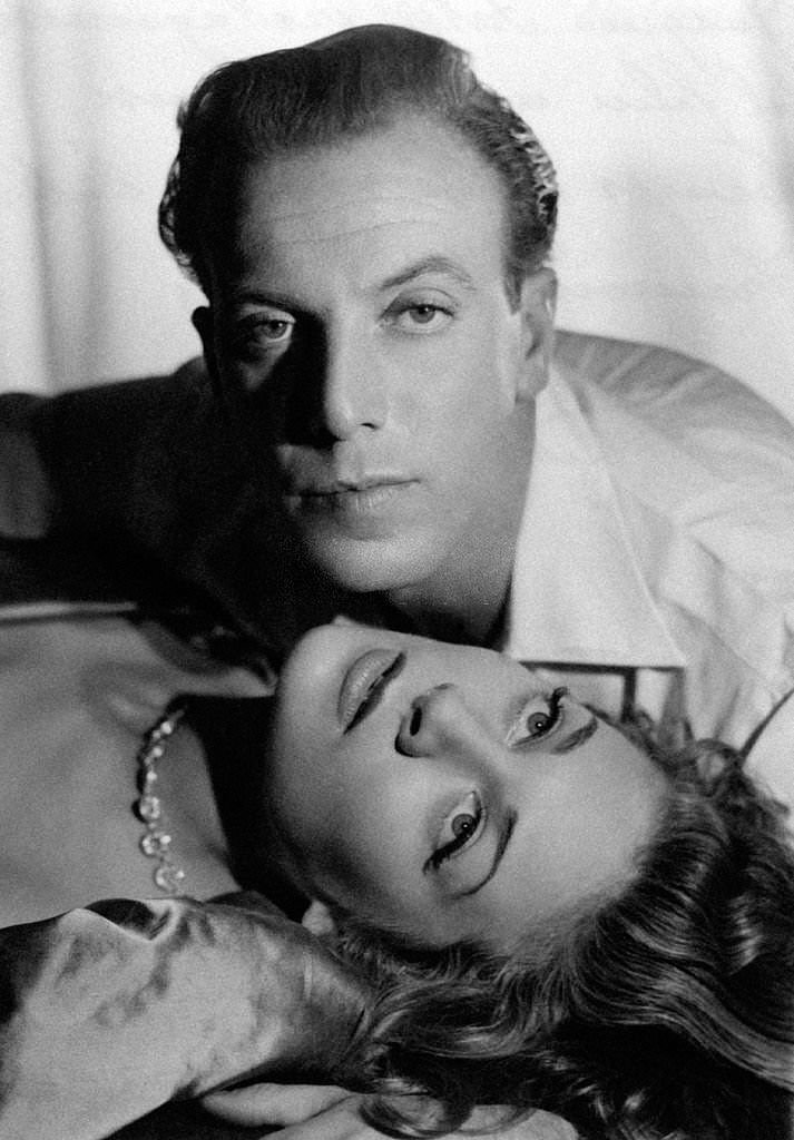 #47 French fashion designer and actor Jacques Fath and French actress Francoise Christophe acting in the film Scandale aux Champs-Elysées, 1949.