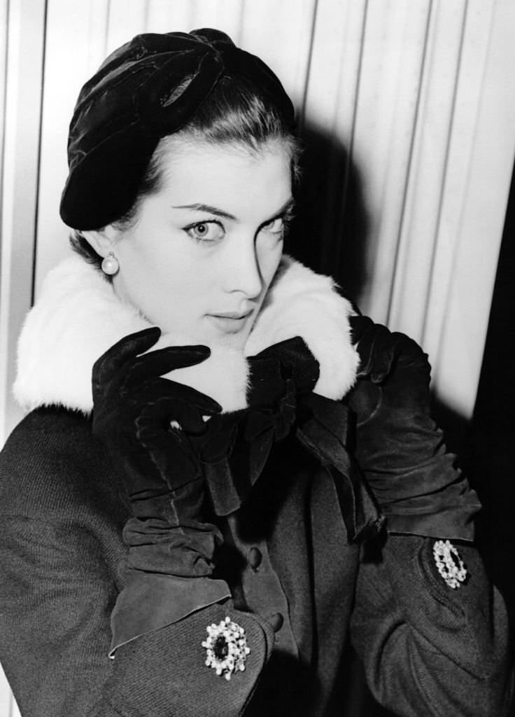#57 Model showing an ermine collar with his black coat from the Autumn 54 collection. Model Jacques Fath at the Dorchester Hotel, London on September 29, 1954.