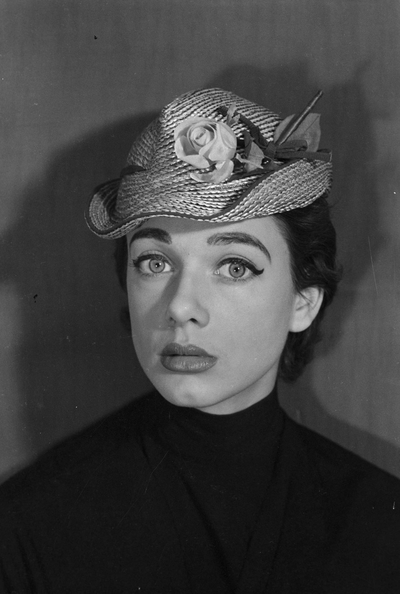 #82 Paule, a model discovered by Jacques Fath, presents spring hats. Hat ‘La belote’ by Svend, 1953